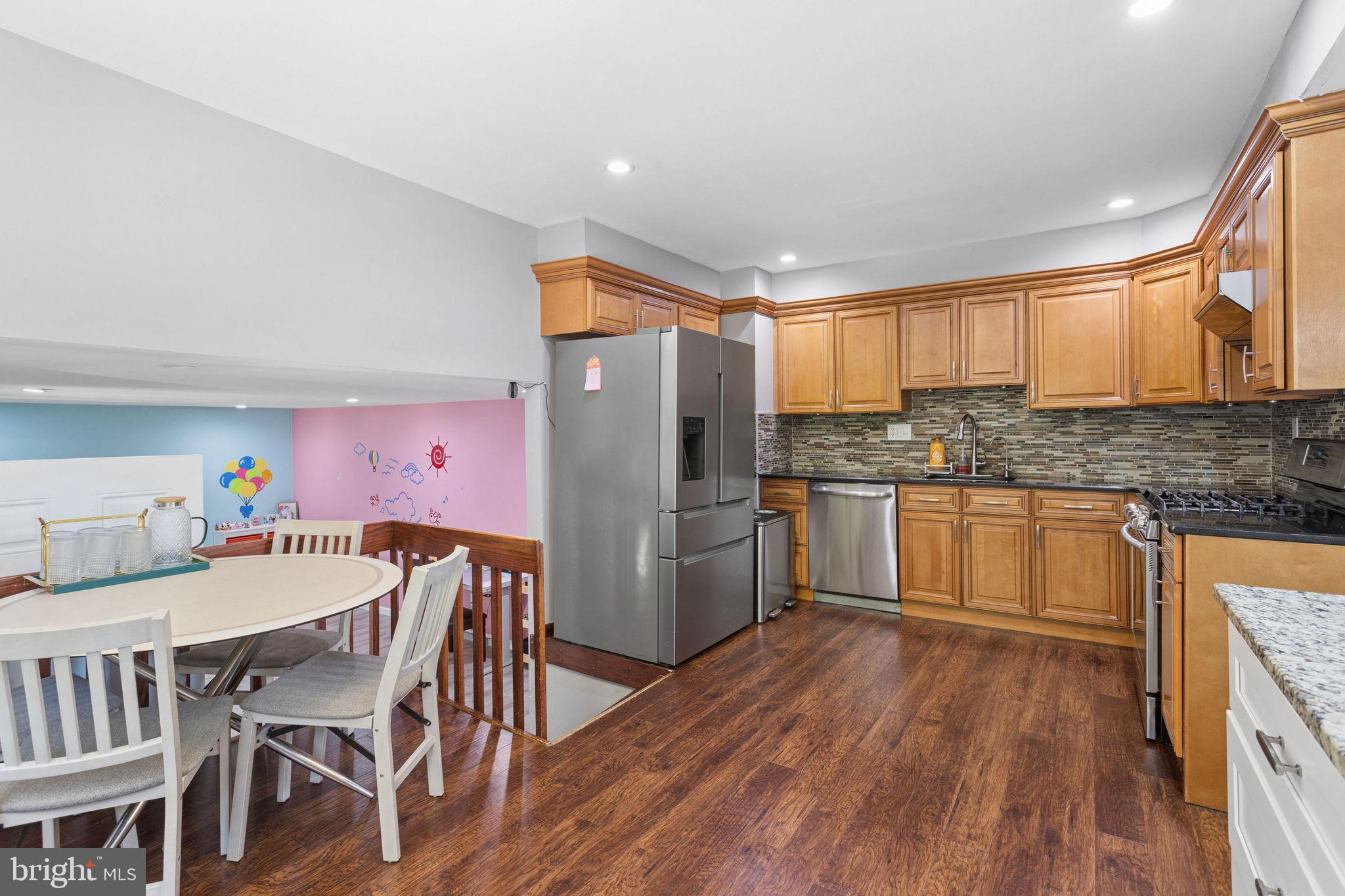 252 Sandringham Road Cherry Hill, NJ 08003 - Photo 13 of 31 a kitchen with granite countertop cabinets stainless steel appliances and dining table