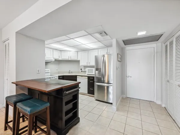 a kitchen with a sink appliances and cabinets