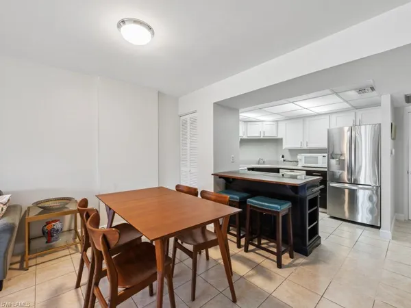 a kitchen with a table and chairs in it