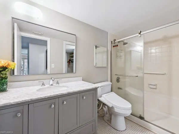 a bathroom with a granite countertop sink toilet and shower