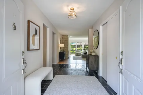 a view of a hallway with a livingroom and dining room