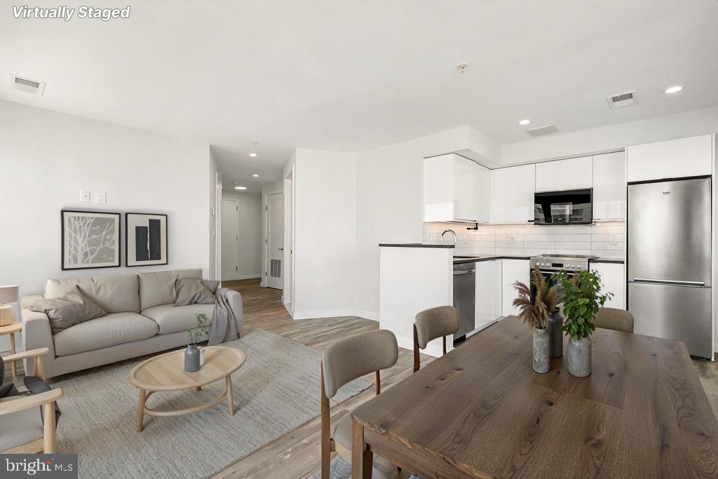 700 Roeder Road, Unit 603 Silver Spring, MD 20910 - Photo 3 of 21 a living room with furniture and a refrigerator