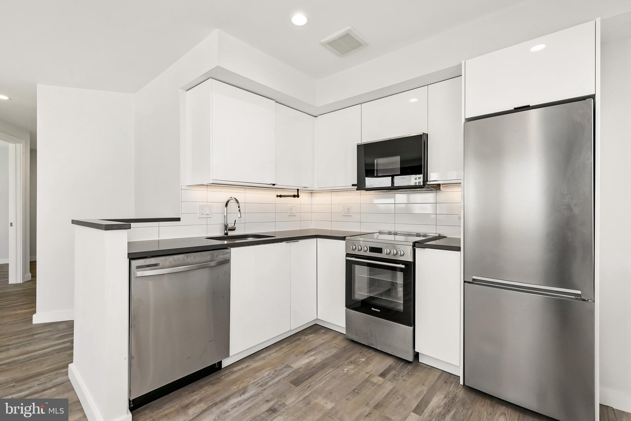 700 Roeder Road, Unit 603 Silver Spring, MD 20910 - Photo 5 of 21 a kitchen with a refrigerator stove and sink