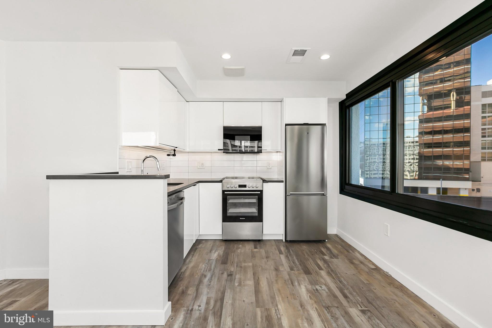 700 Roeder Road, Unit 603 Silver Spring, MD 20910 - Photo 6 of 21 a kitchen with a refrigerator and a stove top oven