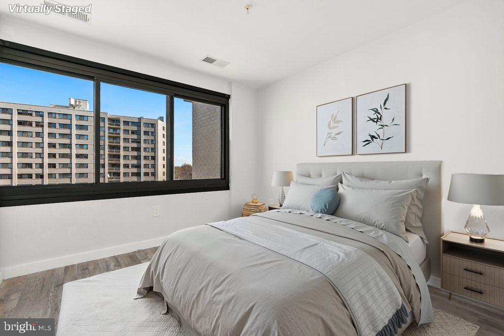 700 Roeder Road, Unit 603 Silver Spring, MD 20910 - Photo 7 of 21 a bedroom with a bed and a large window