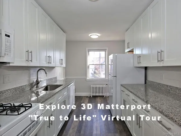 a kitchen with granite countertop a stove a sink dishwasher a refrigerator and wooden cabinets with wooden floor