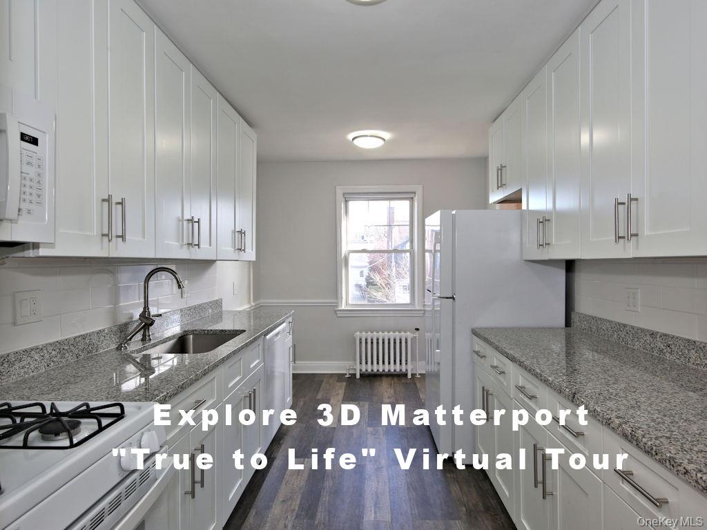 a kitchen with granite countertop a stove a sink dishwasher a refrigerator and wooden cabinets with wooden floor