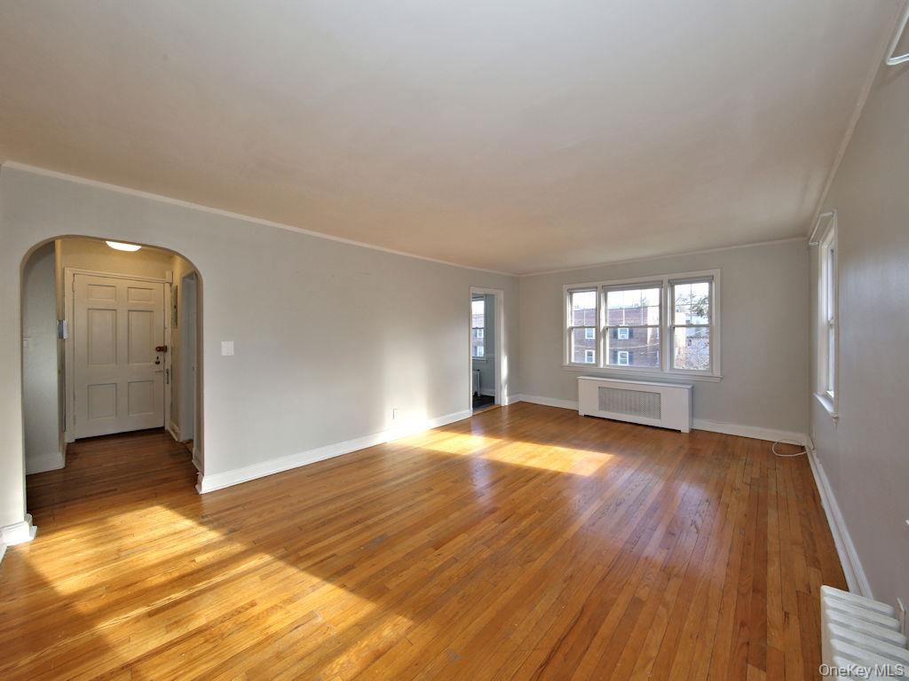 5 Laurel Street, Unit A3 Rye, NY 10580 - Photo 4 of 8 an empty room with wooden floor and windows