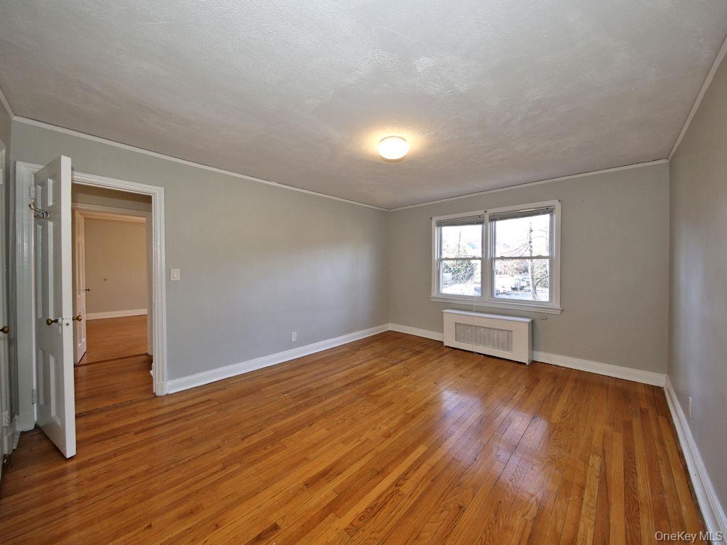 5 Laurel Street, Unit A3 Rye, NY 10580 - Photo 6 of 8 an empty room with wooden floor and windows