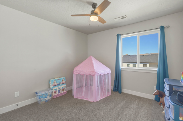 836 South 250 West Vernal, UT 84078 - Photo 34 of 56 Recreation room with carpet flooring, a ceiling fan, and a textured ceiling