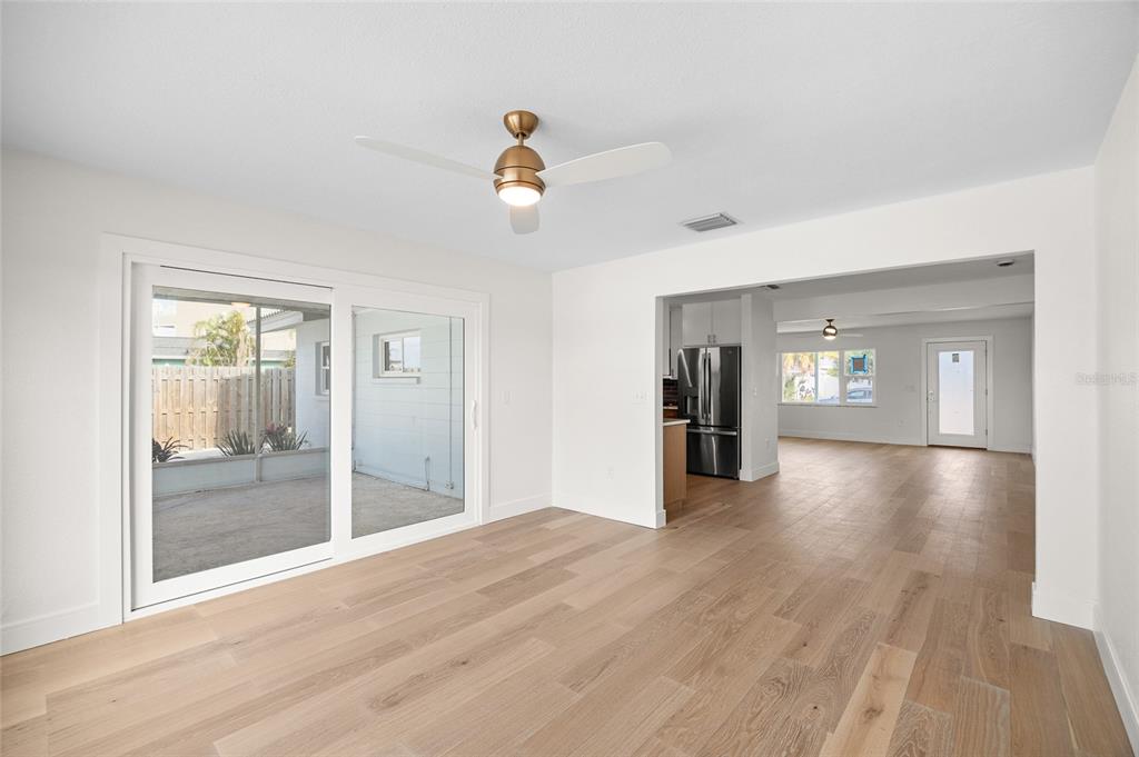 360 145th Avenue Madeira Beach, FL 33708 - Photo 13 of 64 a view of a hallway with wooden floor and a living room