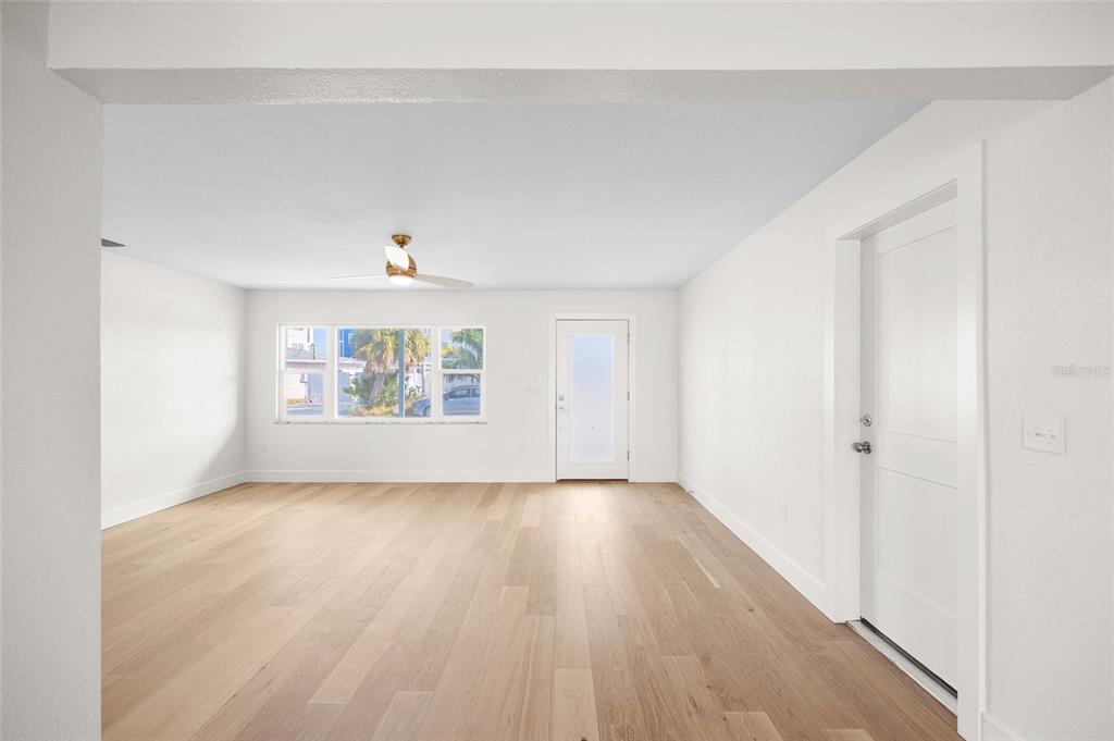 360 145th Avenue Madeira Beach, FL 33708 - Photo 20 of 64 a view of an empty room with a window and wooden floor