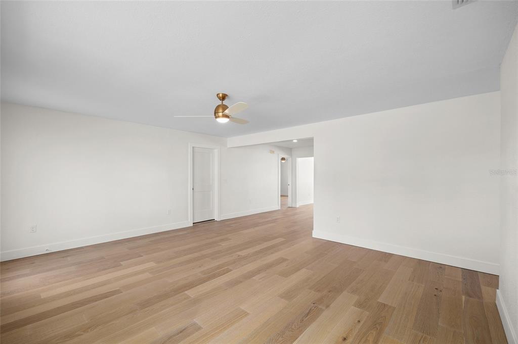 360 145th Avenue Madeira Beach, FL 33708 - Photo 21 of 64 a view of an empty room with wooden floor