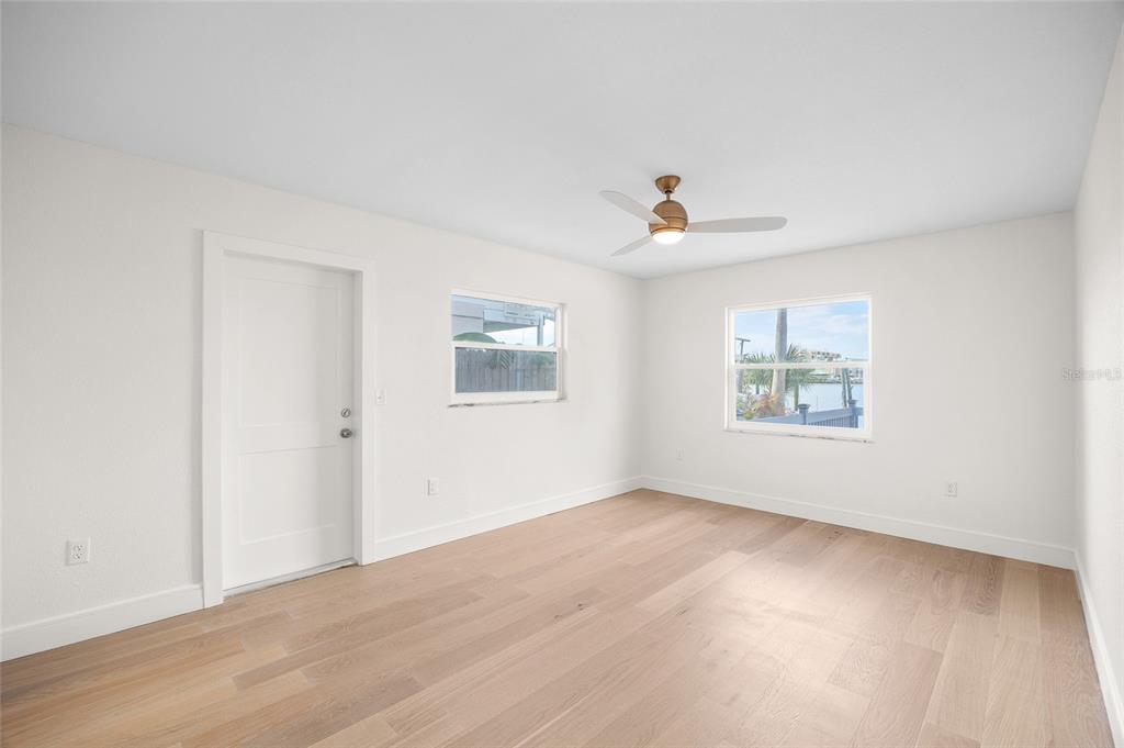 360 145th Avenue Madeira Beach, FL 33708 - Photo 22 of 64 wooden floor in an empty room with a window