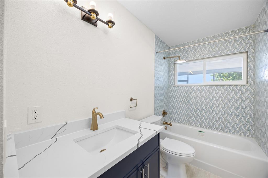 360 145th Avenue Madeira Beach, FL 33708 - Photo 28 of 64 a bathroom with a sink toilet and shower