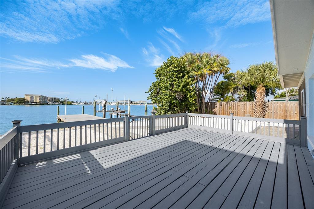 360 145th Avenue Madeira Beach, FL 33708 - Photo 38 of 64 a view of a wooden deck with a yard