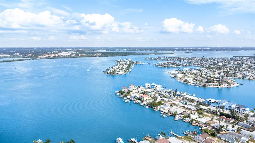 360 145th Avenue Madeira Beach, FL 33708 - Photo 54 of 64 a view of a lake with a building in the background