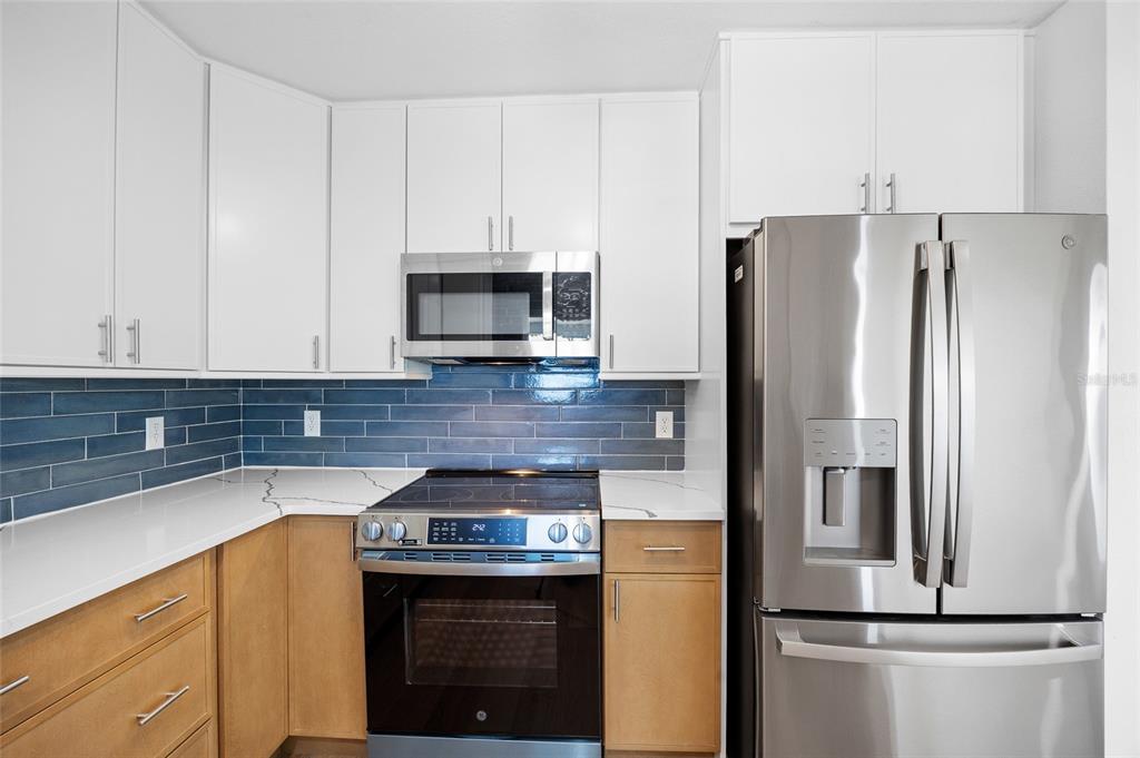 360 145th Avenue Madeira Beach, FL 33708 - Photo 6 of 64 a kitchen with a refrigerator sink and microwave