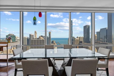 a dining room with furniture and wooden floor