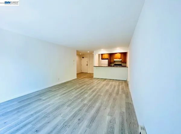 a view of a room with wooden floor kitchen window and wooden floor