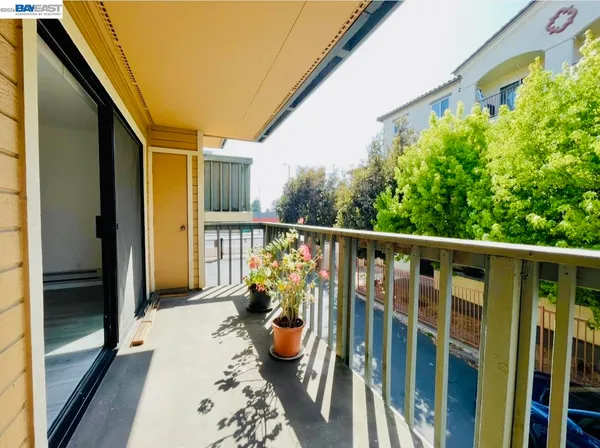a balcony with furniture and potted plants