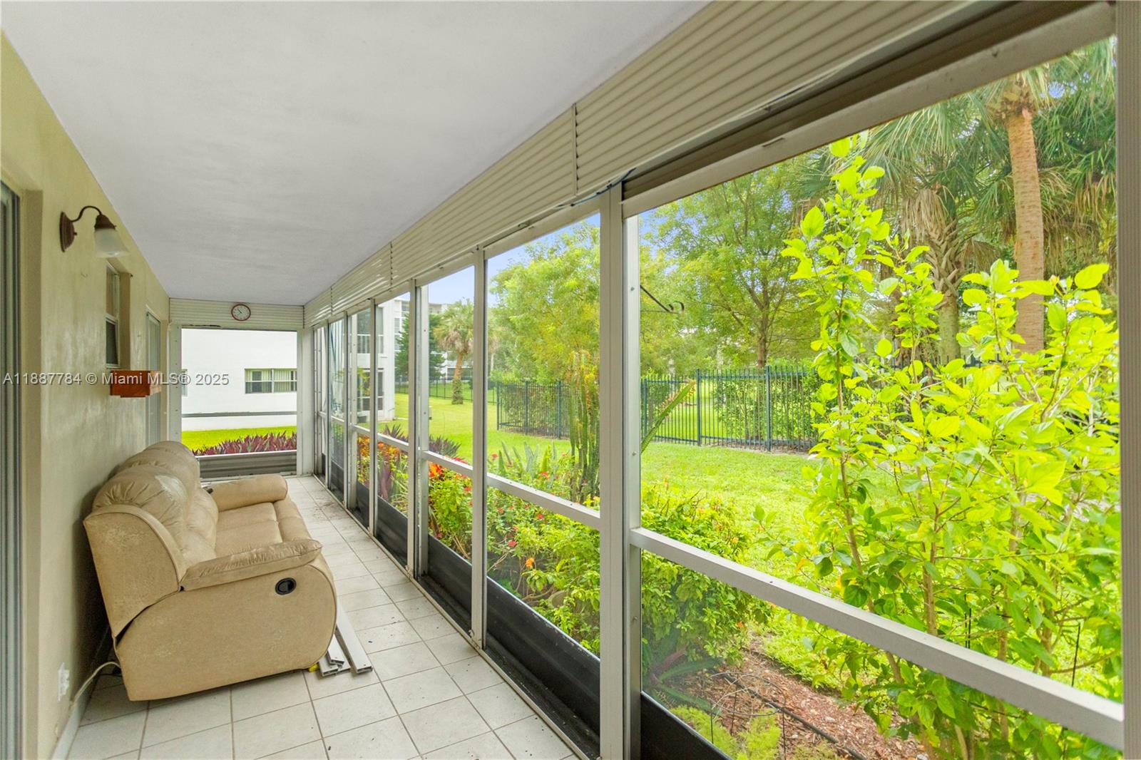 a living room with large trees and furniture