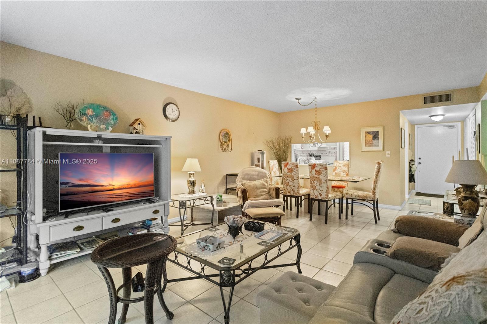 4800 Hillcrest Lane, Unit 101 Hollywood, FL 33021 - Photo 13 of 35 a living room with furniture and a flat screen tv