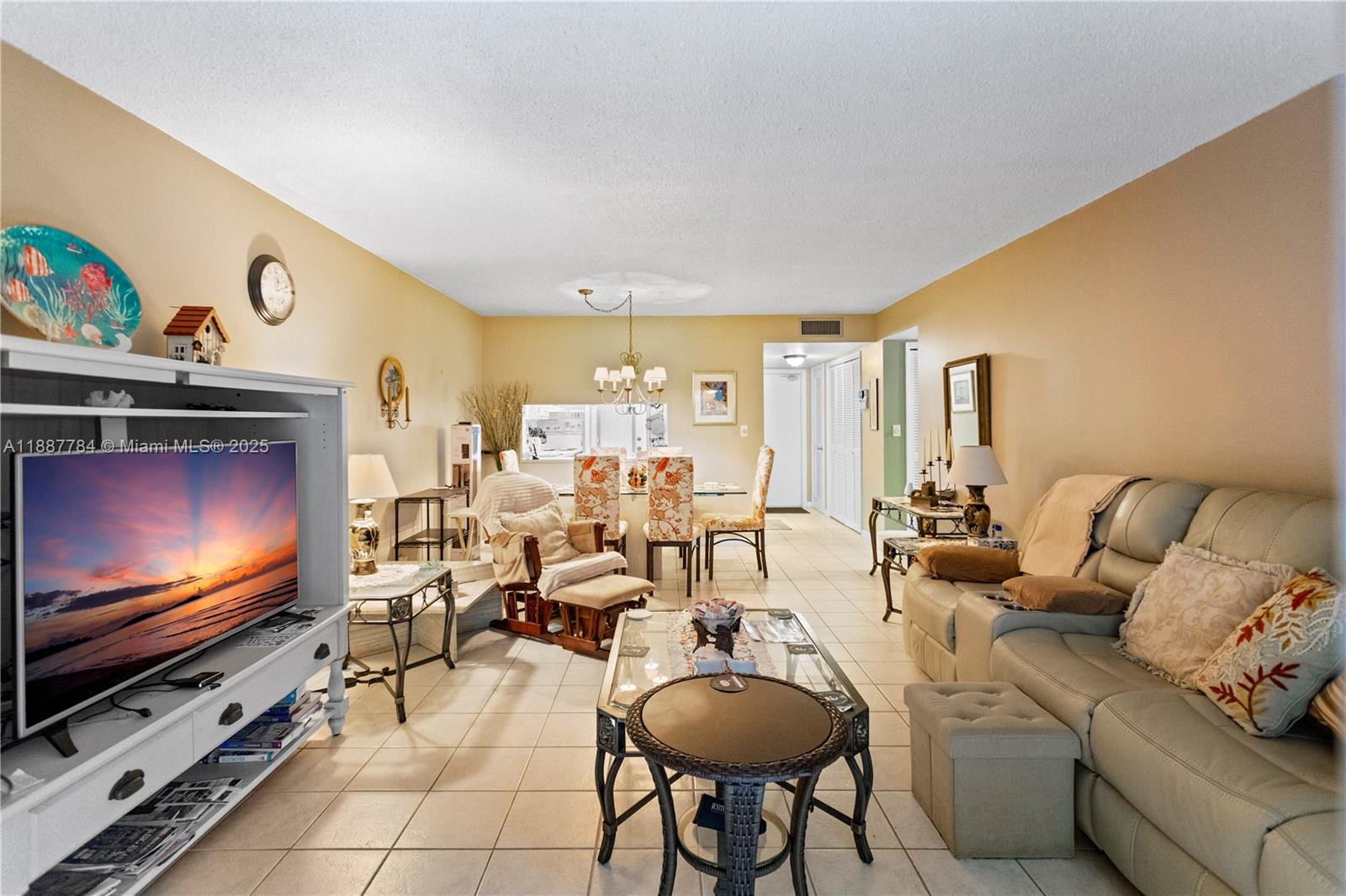 4800 Hillcrest Lane, Unit 101 Hollywood, FL 33021 - Photo 14 of 35 a living room with furniture and a flat screen tv