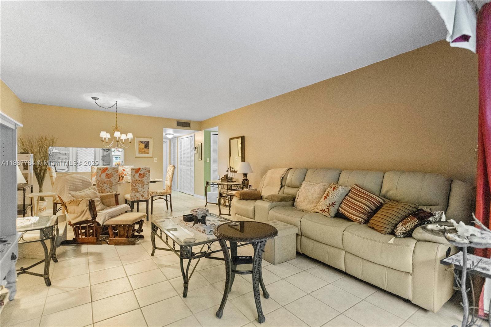 4800 Hillcrest Lane, Unit 101 Hollywood, FL 33021 - Photo 15 of 35 a living room with furniture and a table