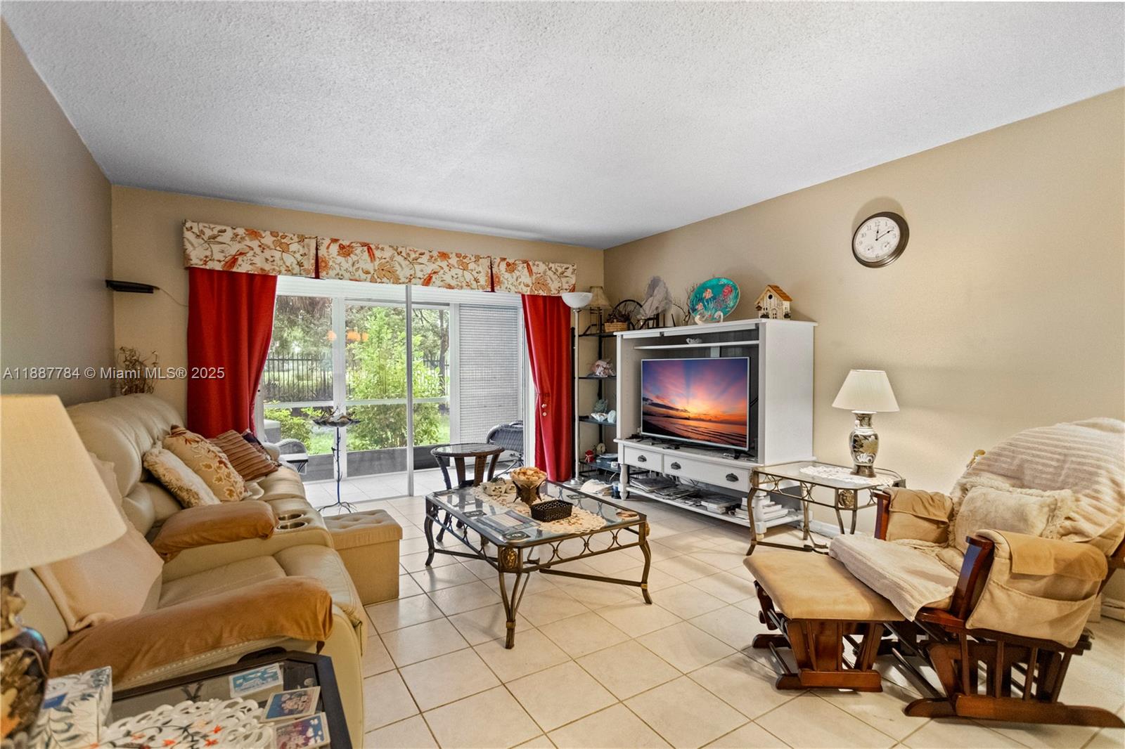 4800 Hillcrest Lane, Unit 101 Hollywood, FL 33021 - Photo 16 of 35 a living room with furniture and a flat screen tv