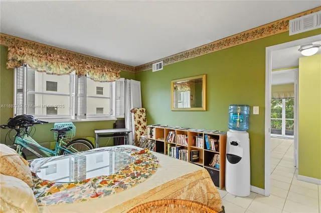 a living room with furniture and a baby crib