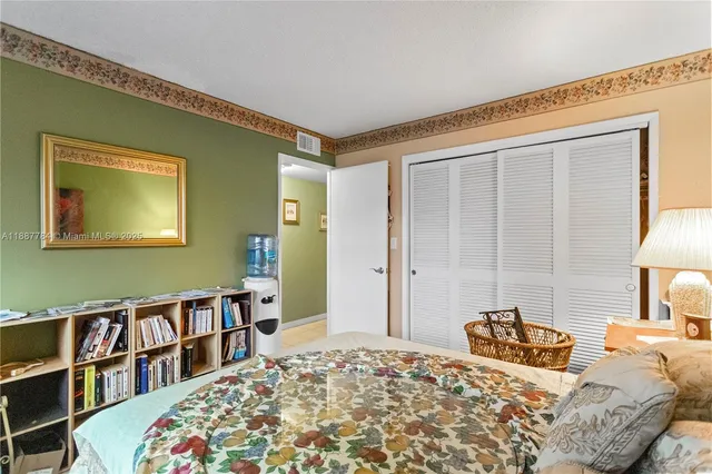 a bedroom with a bed and a book shelf