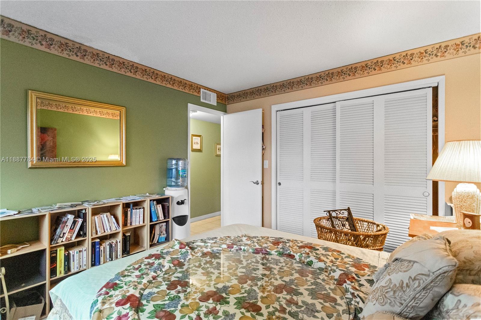 4800 Hillcrest Lane, Unit 101 Hollywood, FL 33021 - Photo 20 of 35 a bedroom with a bed and a book shelf