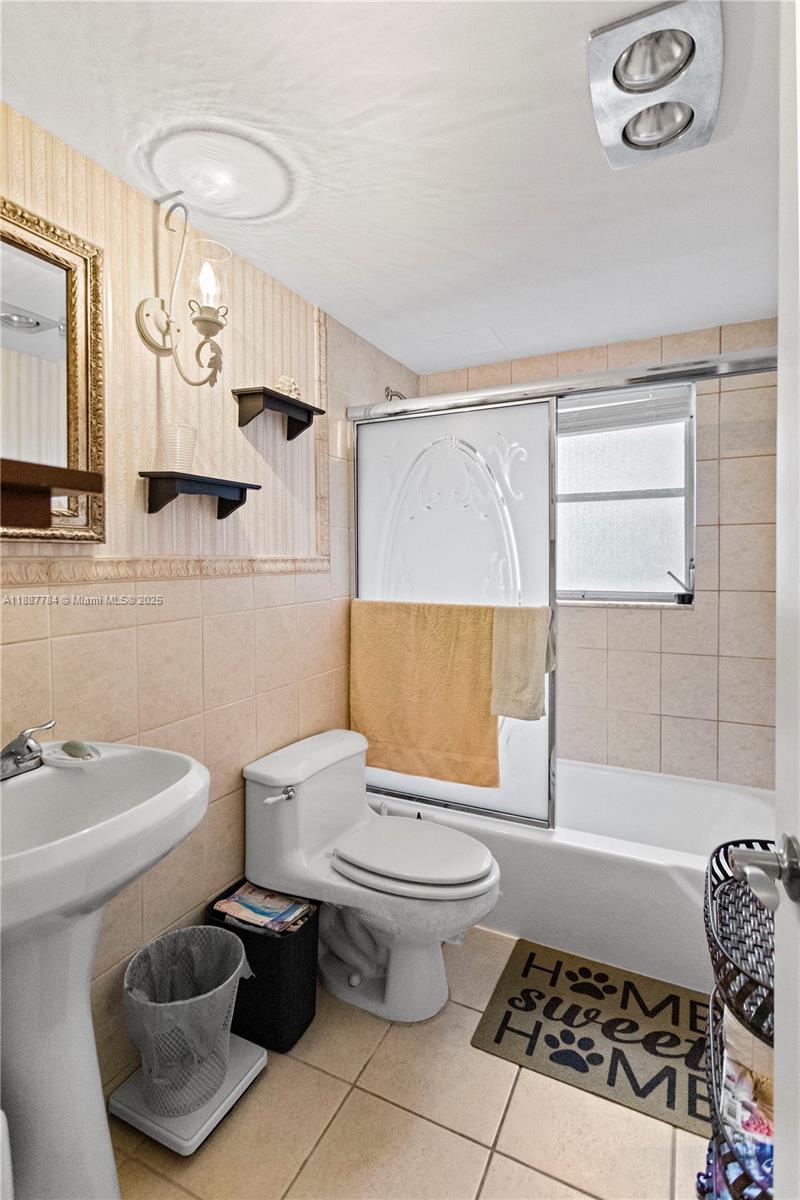 4800 Hillcrest Lane, Unit 101 Hollywood, FL 33021 - Photo 22 of 35 a bathroom with a toilet a sink and a mirror