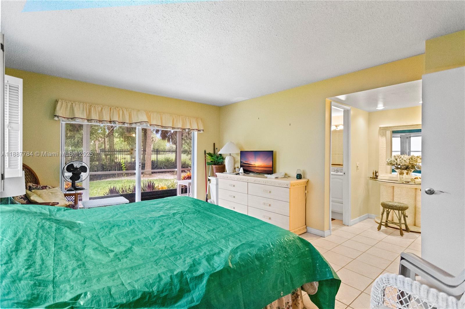 4800 Hillcrest Lane, Unit 101 Hollywood, FL 33021 - Photo 24 of 35 a living room with a flat screen tv and floor to ceiling window