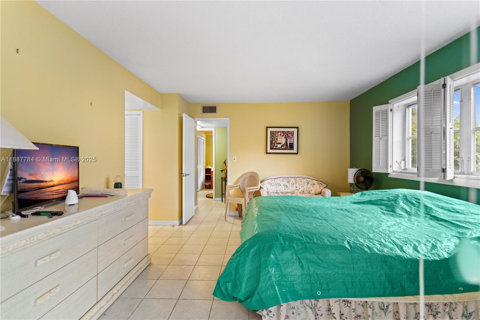 4800 Hillcrest Lane, Unit 101 Hollywood, FL 33021 - Photo 27 of 35 a living room with a couch and a flat screen tv