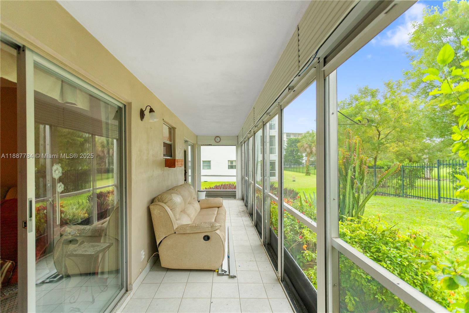 4800 Hillcrest Lane, Unit 101 Hollywood, FL 33021 - Photo 3 of 35 a view of a porch with furniture and a yard