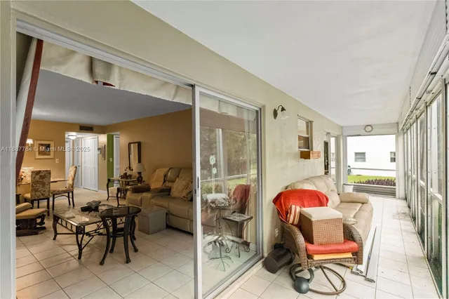 a living room filled with furniture and a potted plant