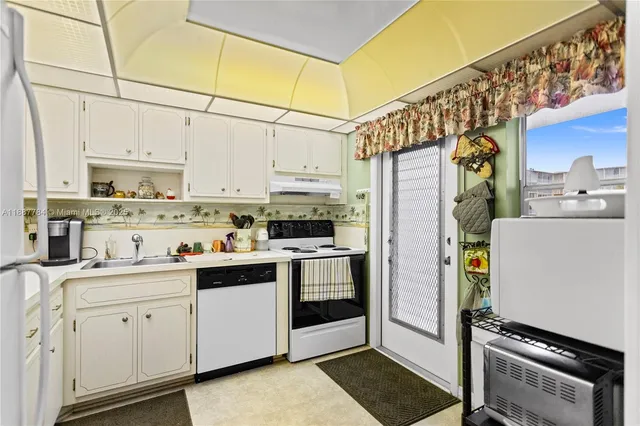 a kitchen with stainless steel appliances a stove a sink and cabinets