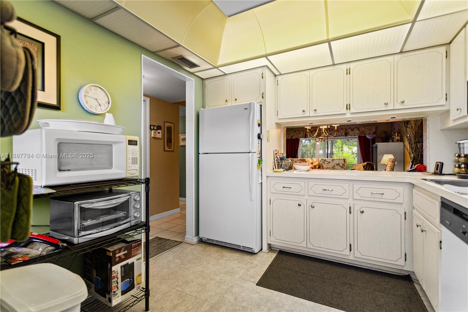 4800 Hillcrest Lane, Unit 101 Hollywood, FL 33021 - Photo 8 of 35 a kitchen with stainless steel appliances a stove microwave and a refrigerator