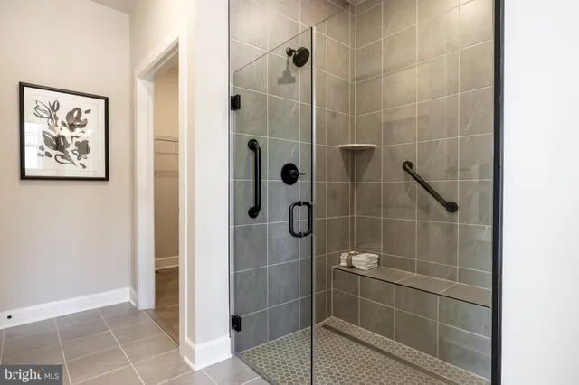 a bedroom with a bed painting on the wall and a window