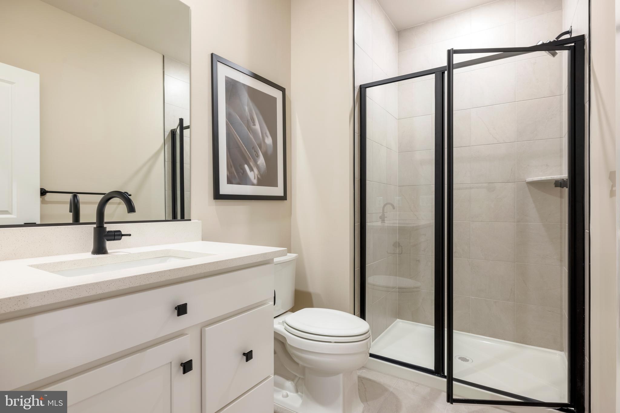 6497 Swimmer Row Way Columbia, MD 21044 - Photo 22 of 41 a bathroom with a toilet a sink and a mirror