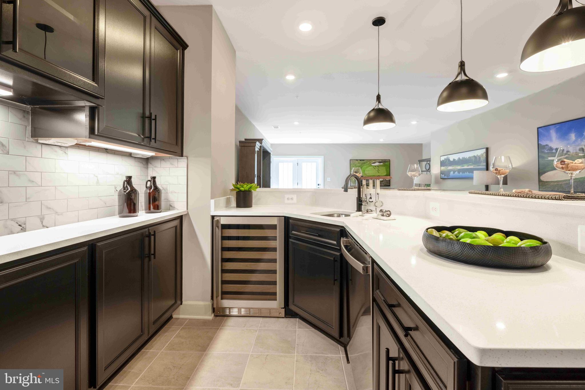 6497 Swimmer Row Way Columbia, MD 21044 - Photo 24 of 41 a kitchen with a sink stainless steel appliances and cabinets