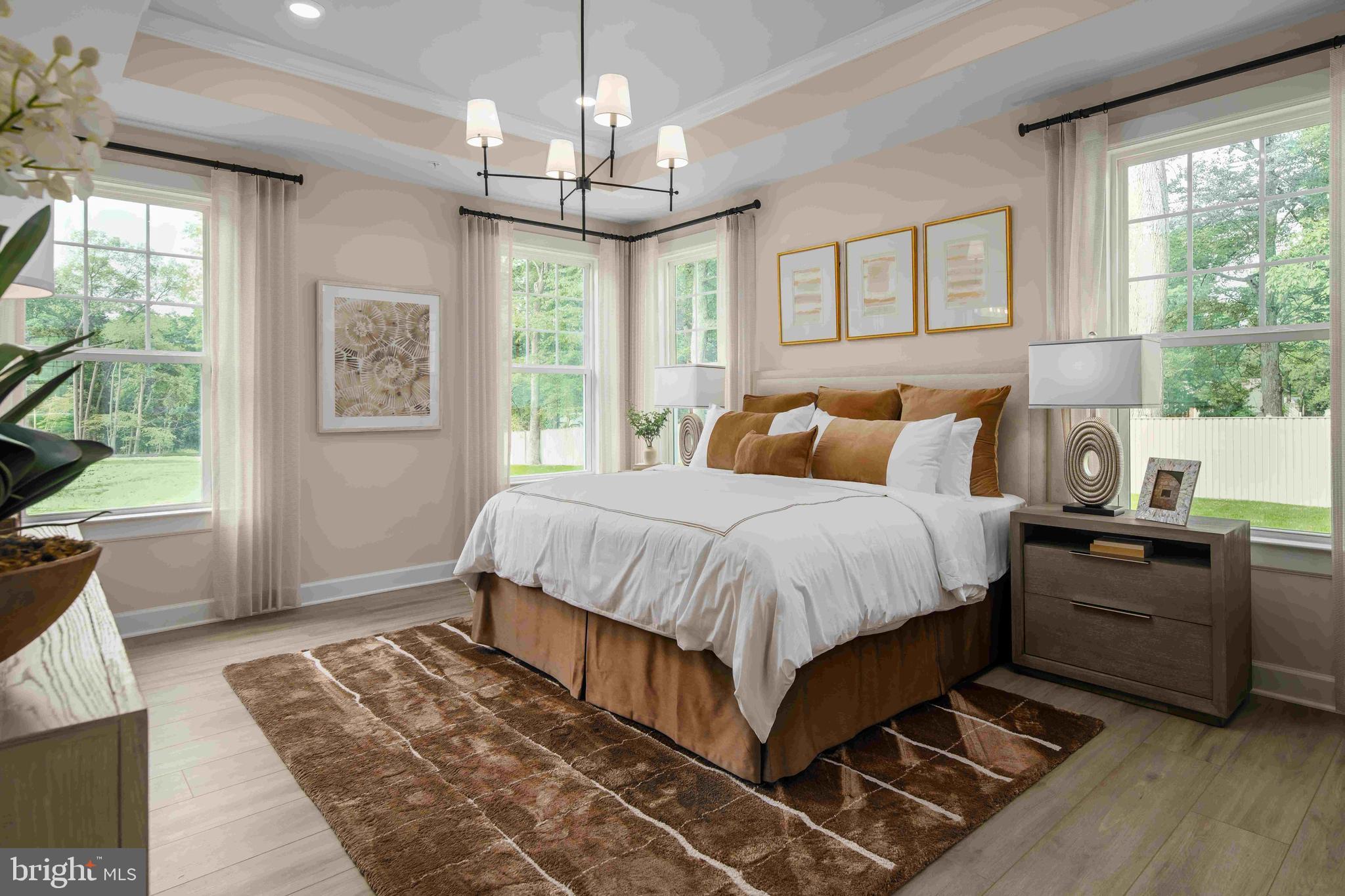 6497 Swimmer Row Way Columbia, MD 21044 - Photo 26 of 41 a spacious bedroom with a bed and wooden floor