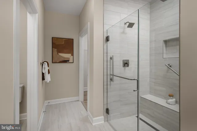 a bathroom with a bathtub sink vanity and mirror