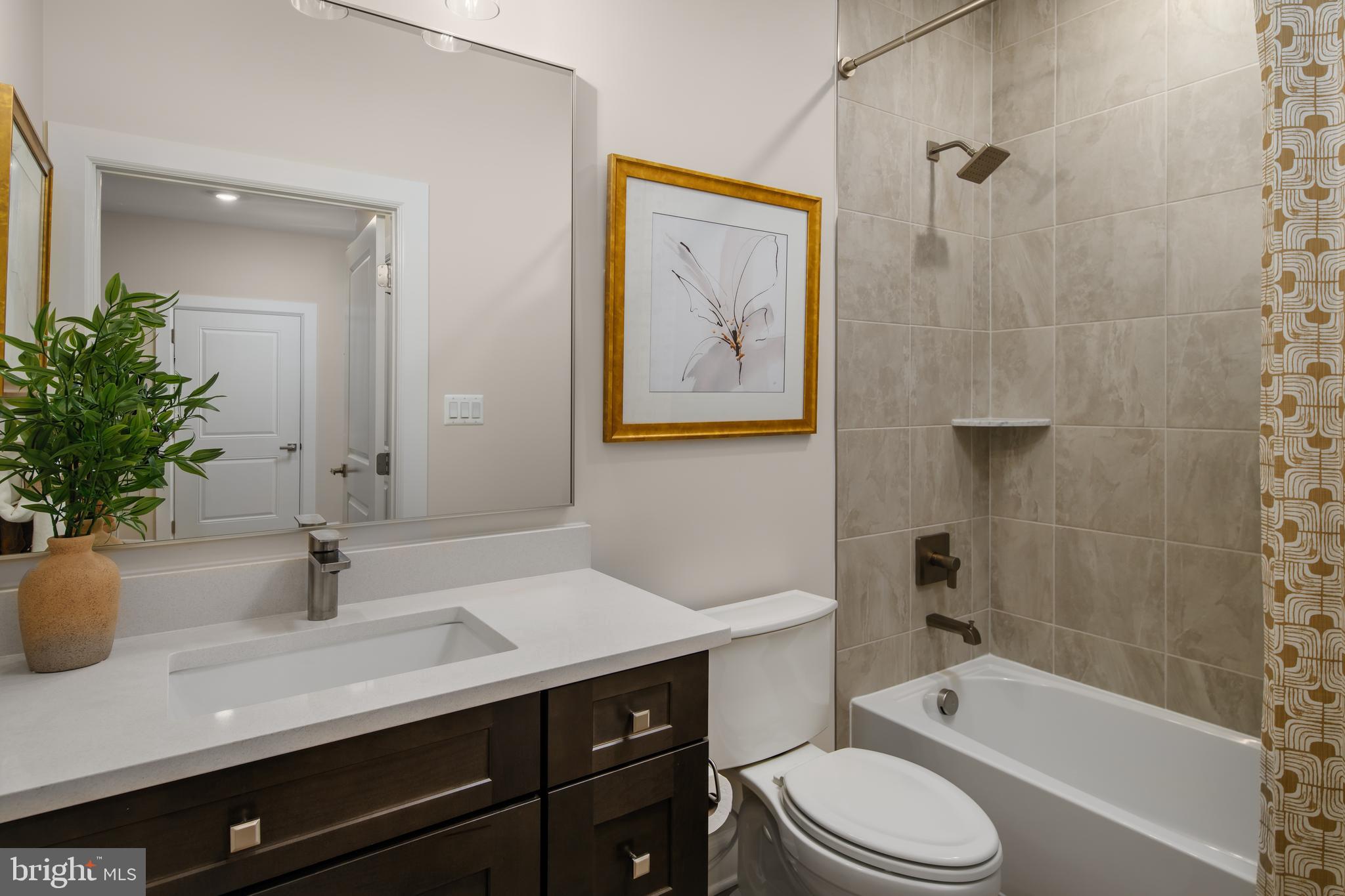 6497 Swimmer Row Way Columbia, MD 21044 - Photo 31 of 41 a bathroom with a sink a toilet a tub and shower