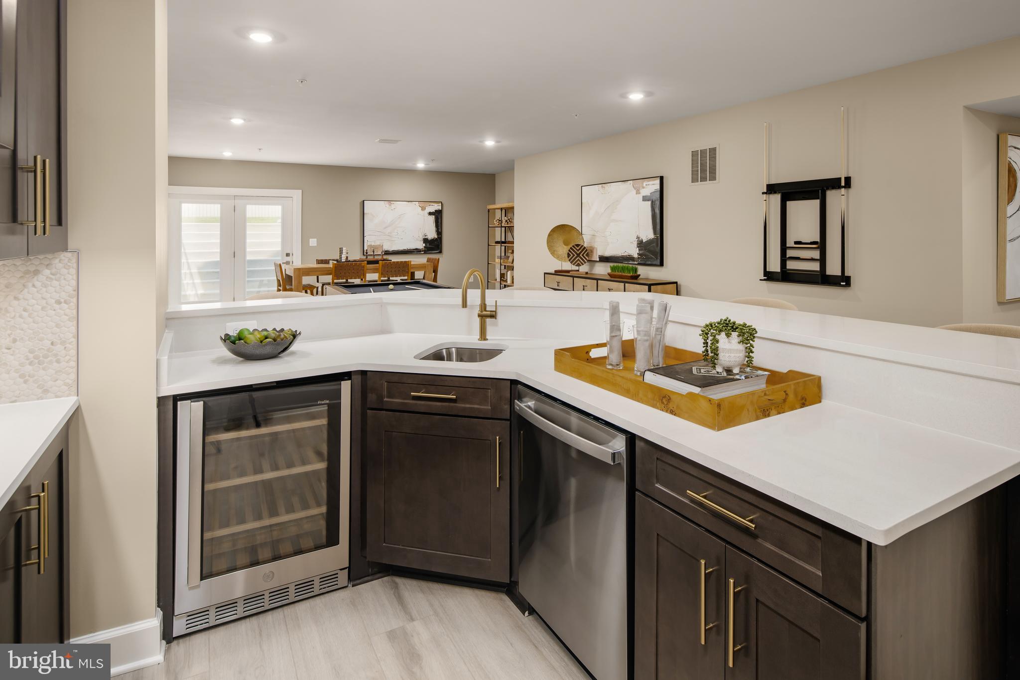 6497 Swimmer Row Way Columbia, MD 21044 - Photo 35 of 41 a kitchen with a sink a stove and cabinets