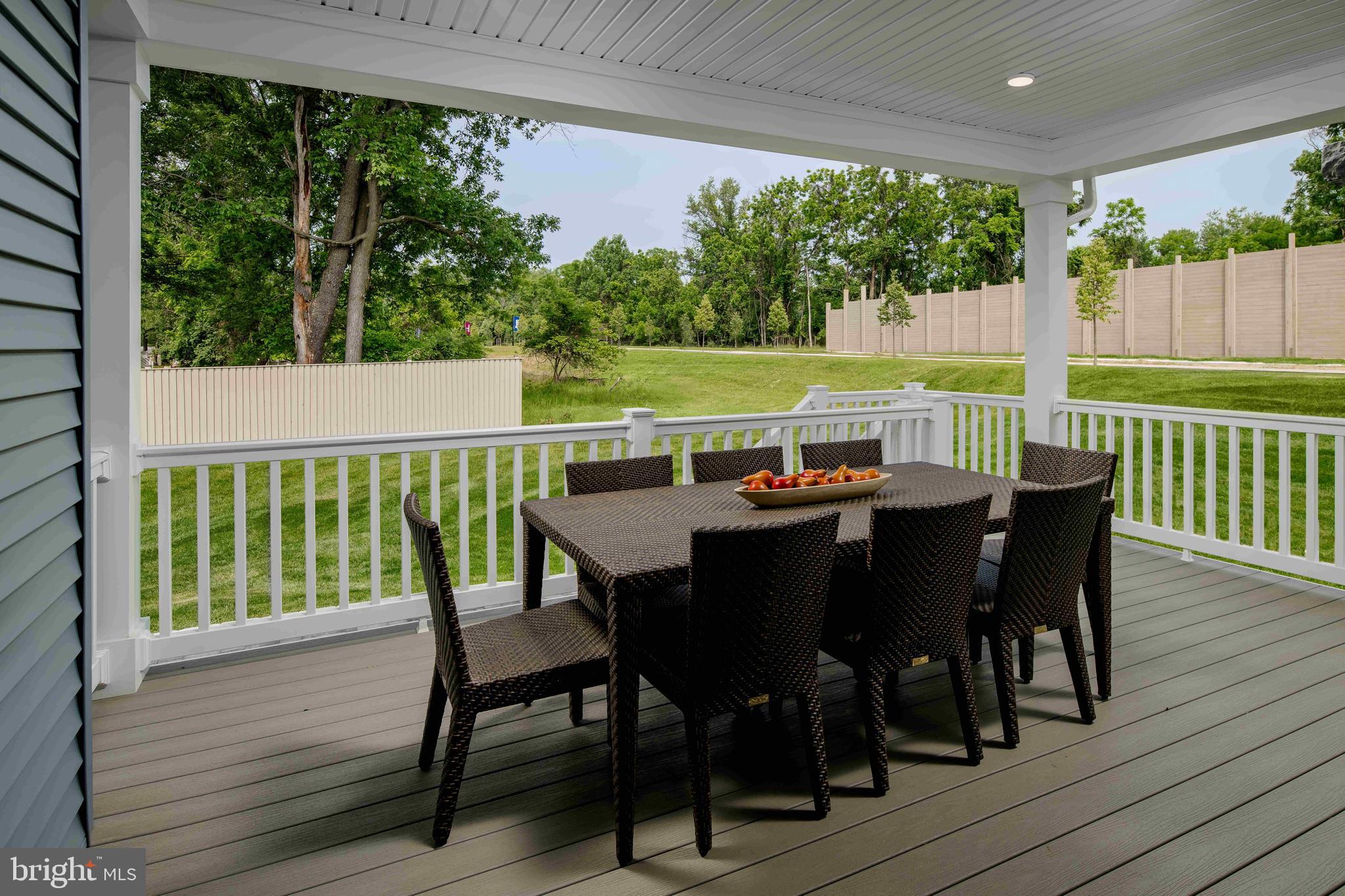 6497 Swimmer Row Way Columbia, MD 21044 - Photo 37 of 41 a view of a dining table and chairs on the roof deck