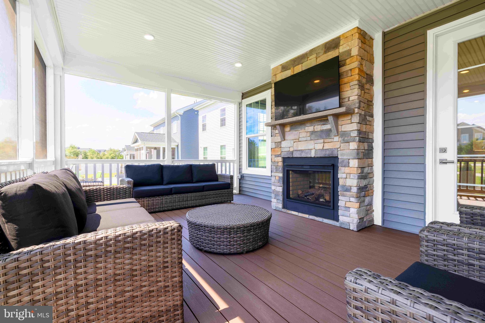 6497 Swimmer Row Way Columbia, MD 21044 - Photo 39 of 41 a living room with furniture a flat screen tv and a fireplace