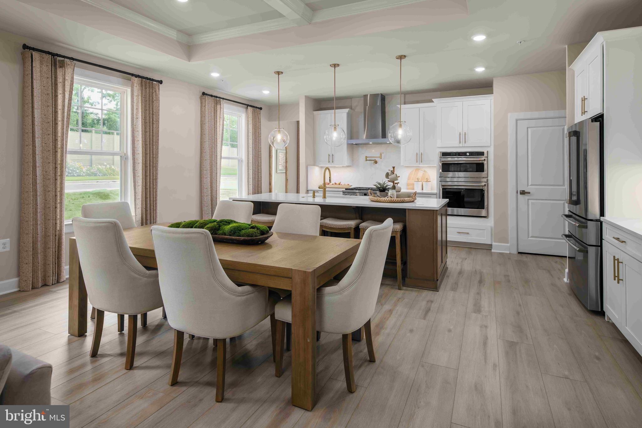 6497 Swimmer Row Way Columbia, MD 21044 - Photo 5 of 41 a view of a dining room with furniture a kitchen and chandelier